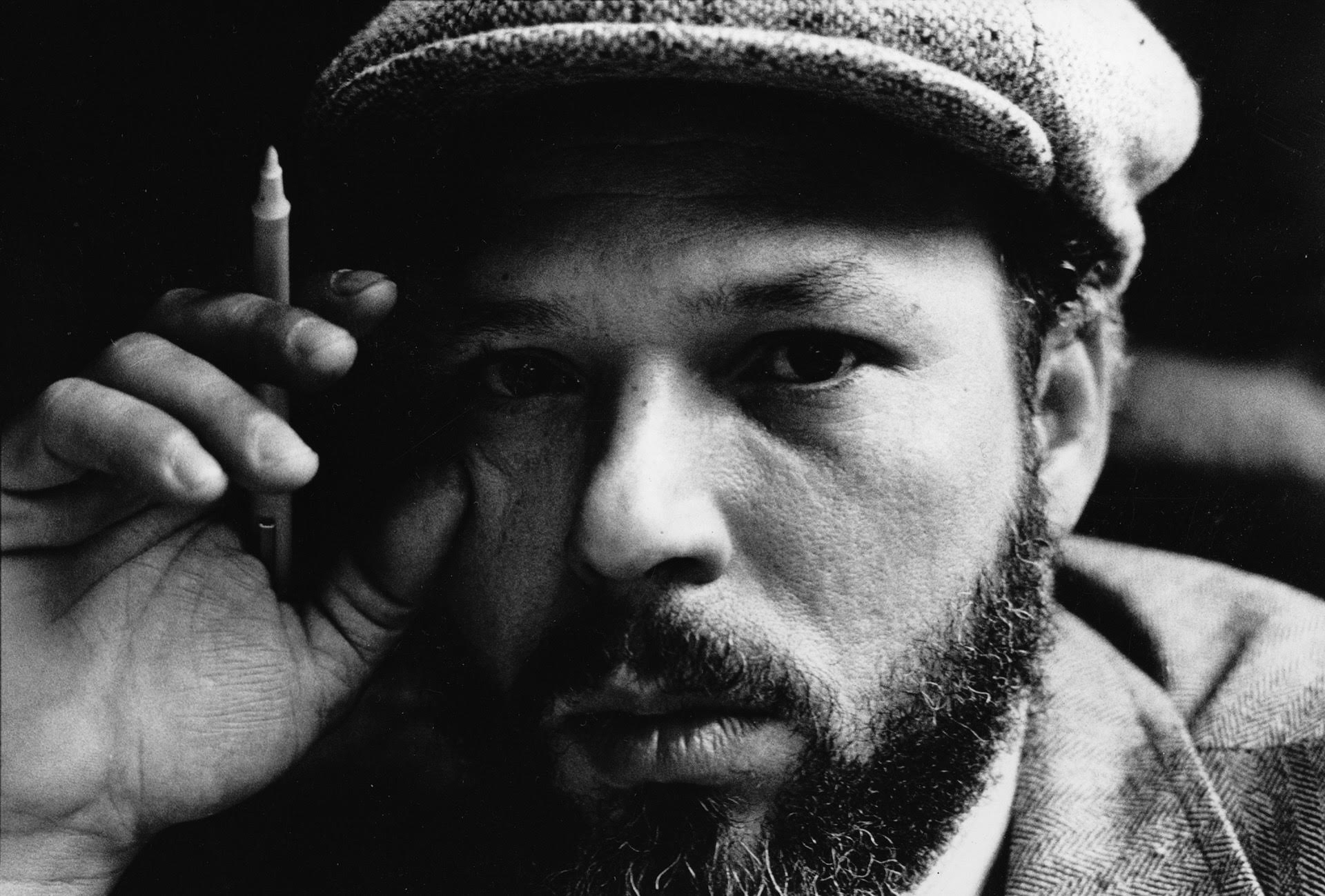 Headshot photo of August Wilson with pen-in-hand